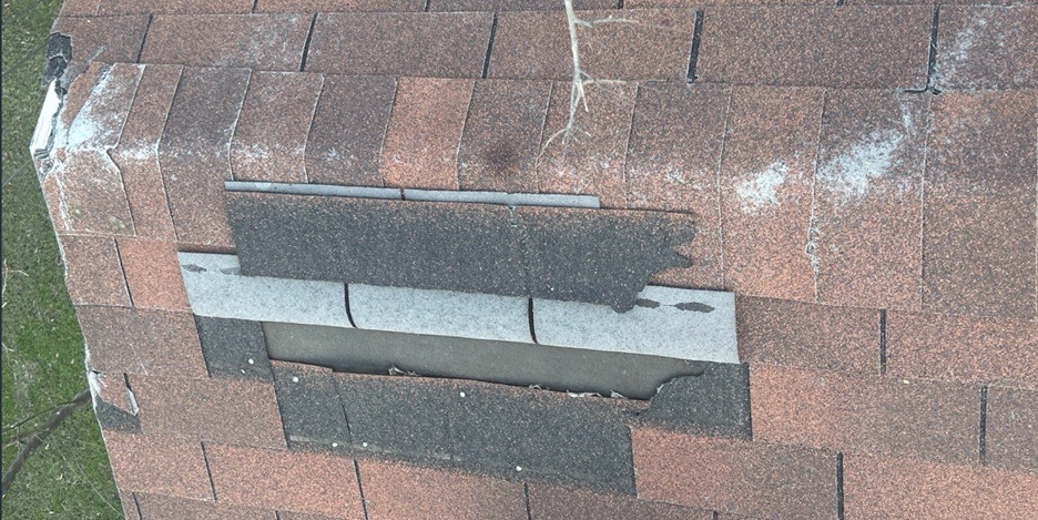 Wind damage roof with missing shingles in Texas